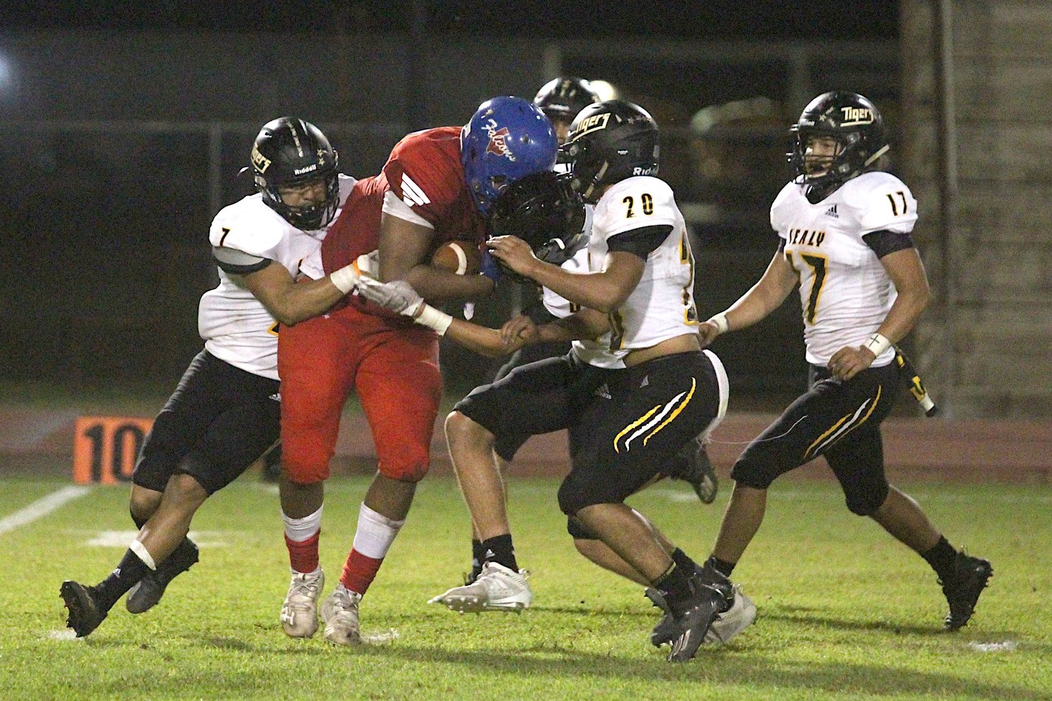 Royal senior tight end Jeremiah Venson drags a host of Sealy defenders after making a catch in the fourth quarter that helped set up the Falcons’ lone score of their district-opening game against the Tigers.